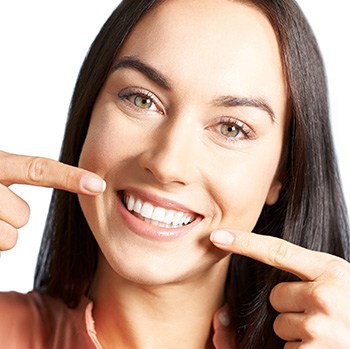 Smiling woman pointing to her teeth