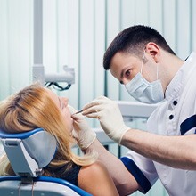 Dentist performing dental work on patient